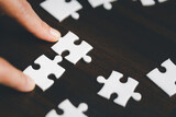 Business woman person hand holding puzzle piece idea for strategy and solution. Closeup part of two white jigsaw connect together. Concept of join cooperation success teamwork-problem corporate team