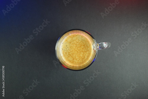 hot black coffee on black table with neon lights
