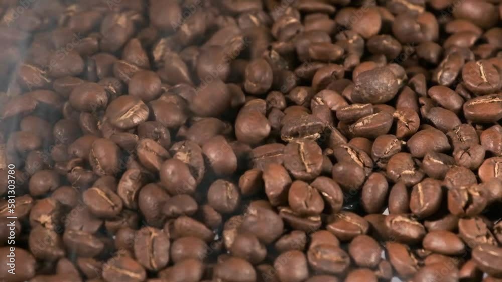 Slow motion of roasted coffee beans falling. Organic coffee seeds. Slow motion of roasted coffee beans falling. Organic coffee seeds.
