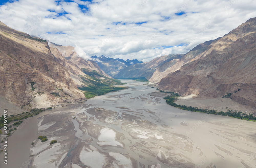 A pond river lake in Karakoram high mountain hills. Nature landscape background, Skardu, Gilgit, Pakistan. Travel on holiday vacation. Glacial ice abstract pattern art texture background