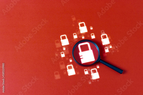 Security search uses a magnifying glass Security key System weaknesses and massive connection information and anti-hacker on a red background.
