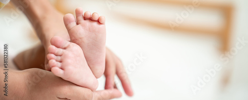 Asian Mother hands in heart shape. Baby feet in mother's hands that mean symblo of love. Mom and her Baby Child. Happy Family concept. Beautiful conceptual image of Mother and newborn baby family © Yellow Boat