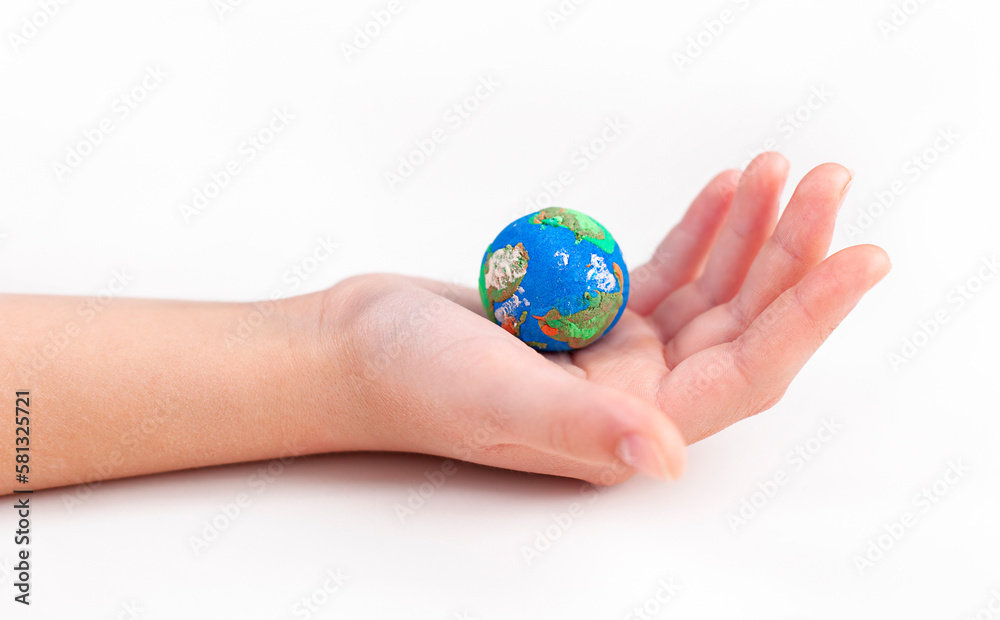In the hand of a man lies a small plasticine globe. In the hand of a man lies a small plasticine globe.