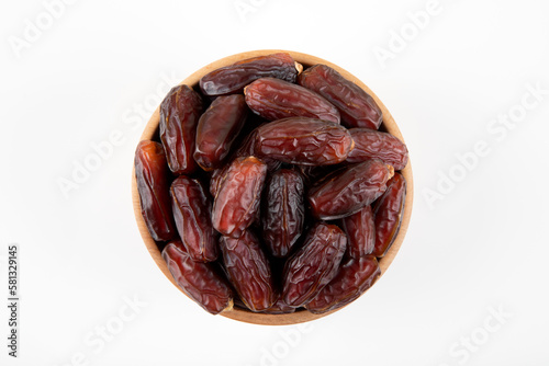 Date fruits in wooden bowl,on white background,top view