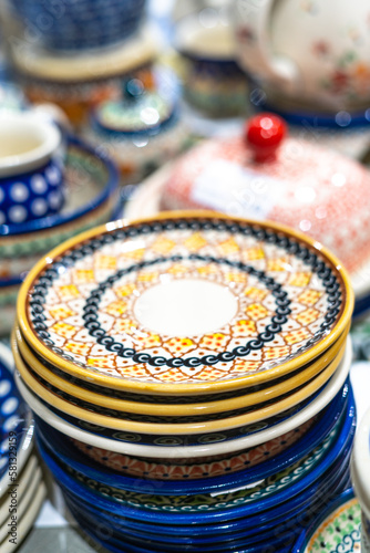 Traditional porcelain plates from Boleslawiec in the shop. Handmade pottery photo