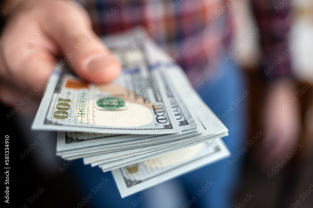 Close up male hand Counting and holding money us dollar. The concept of financial business and crisis. Close up male hand Counting and holding money us dollar. The concept of financial business and crisis.