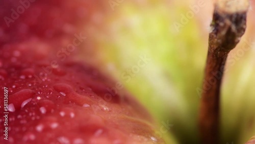 Healthy and Hydrated: A Closeup View of a Rotating Apple with Water Droplets.