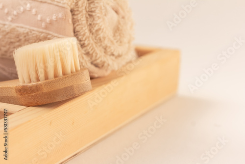 Personal care accessories, shower and bath items. A wooden brush, a wash cloth in a wooden box. Copy space. Zero waste concept.