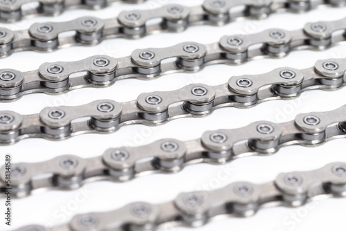 Closeup of New Clean Oiled Bicycle Chain Image Texture Isolated Over White Background With Focus in the Middle of Chain.