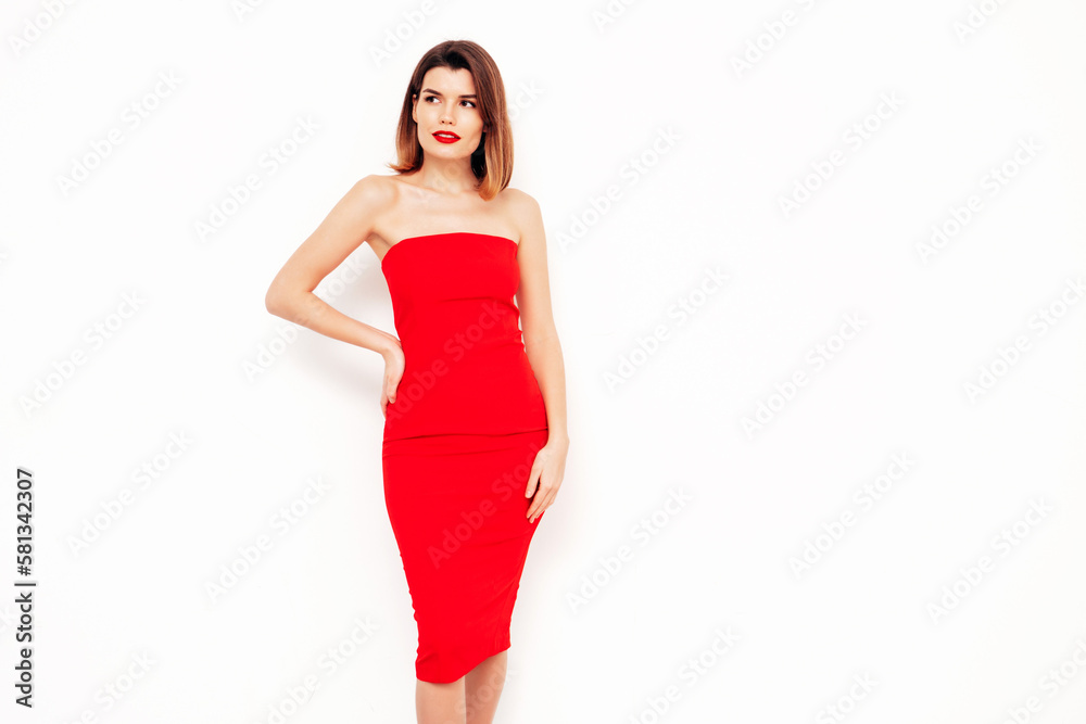 Young beautiful smiling female in trendy summer red evening dress. Sexy carefree brunette woman posing in studio, isolated on white. Positive model with evening makeup. Cheerful and happy. red lips Young beautiful smiling female in trendy summer red evening dress. Sexy carefree brunette woman posing in studio, isolated on white. Positive model with evening makeup. Cheerful and happy. red lips