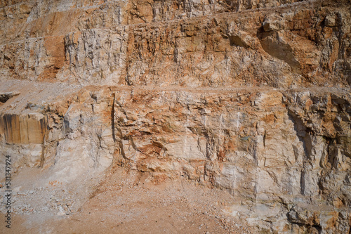 Section of a marble quarry wall. Red marble in a quarry. Panorama of an open pit in the mountains of Italy. Marble quarry in Italy.