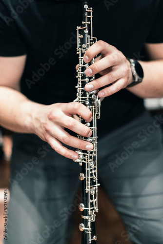 An oboe player practicing the oboe in an orchestral setting