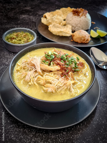 nasi soto ayam is traditional Indonesian yellow soup mainly composed of broth  meat  fried patties and vegetables 