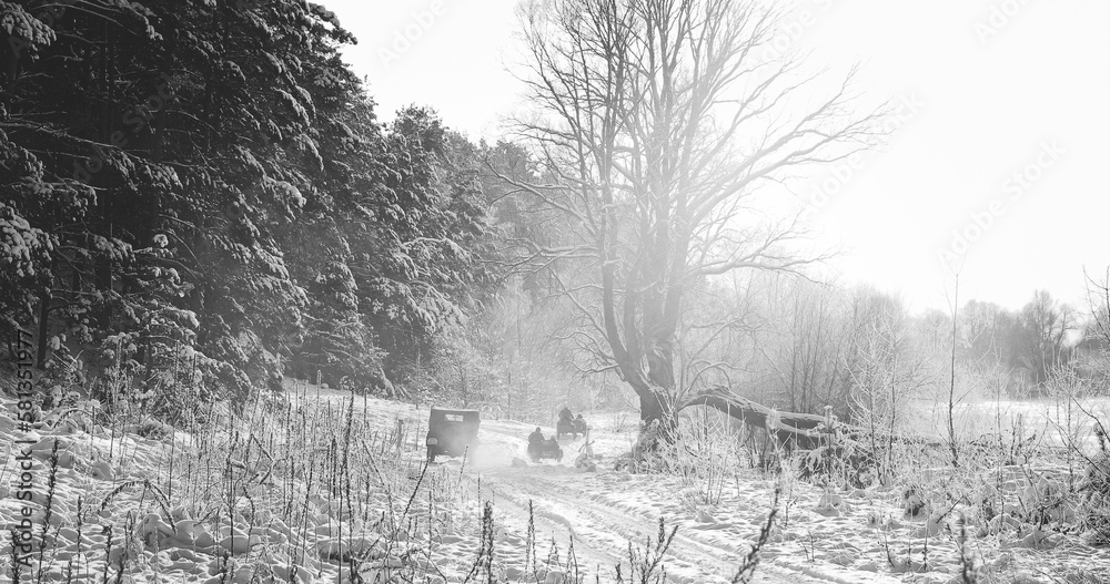 Re-enactors Dressed As World War II German Wehrmacht Infantry Soldiers Driving Old Tricar, Three-wheeled Motorcycle in Winter Snowy Forest.