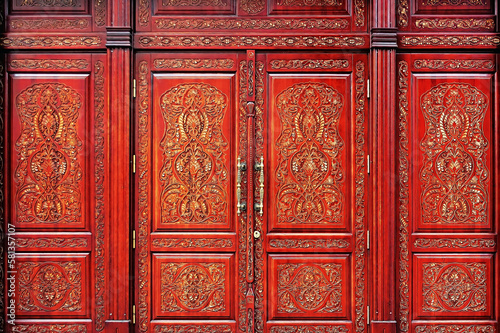 Red ornate doors with golden oriental pattern in Kyiv Ukraine