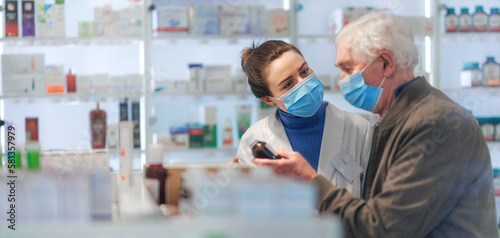 Young pharmacist helping senior man to choos medication. © Halfpoint