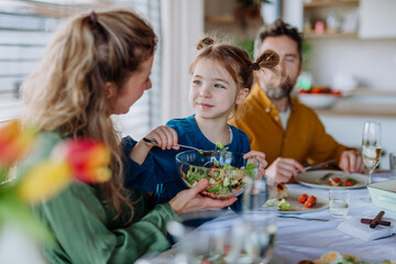 Happy family having Easter dinner together in their home.