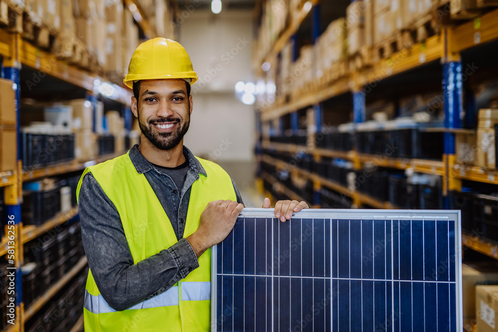 Portrait of warehouse worker with solar panel. Portrait of warehouse worker with solar panel.