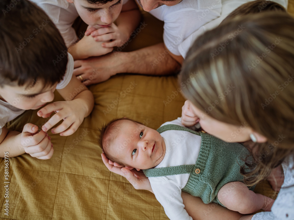 Big family with four kids enjoying their newborn baby. Big family with four kids enjoying their newborn baby.