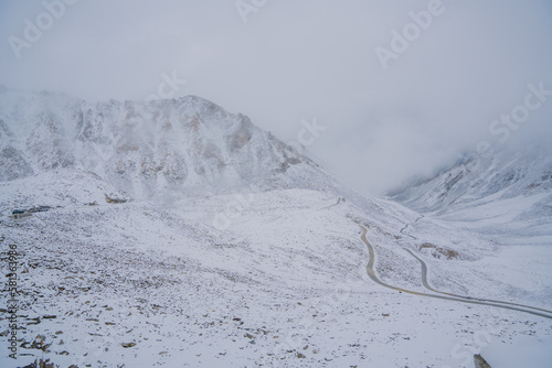 Beautiful view of Khardung La Pass- Leh road on the high mountain covered with snow. It is the highest pass in the world that motorbikes can run through at Ladakh, Leh, India