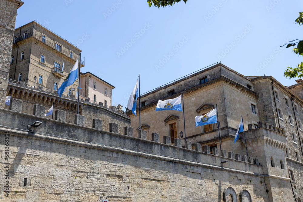 Obraz na płótnie SAN MARINO, JULY 5, 2022 - City walls and flags of the city state of San Marino, Europe w salonie