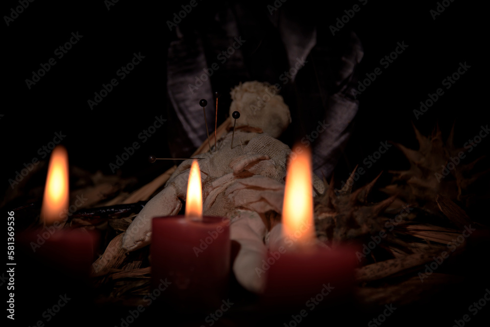 Voodoo Doll on a wooden background with dramatic lighting. Voodoo Doll on a wooden background with dramatic lighting.