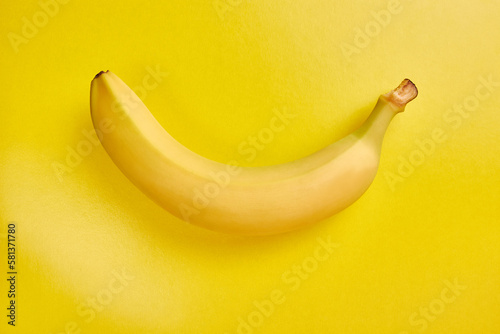 Yellow ripe banana on a yellow background.