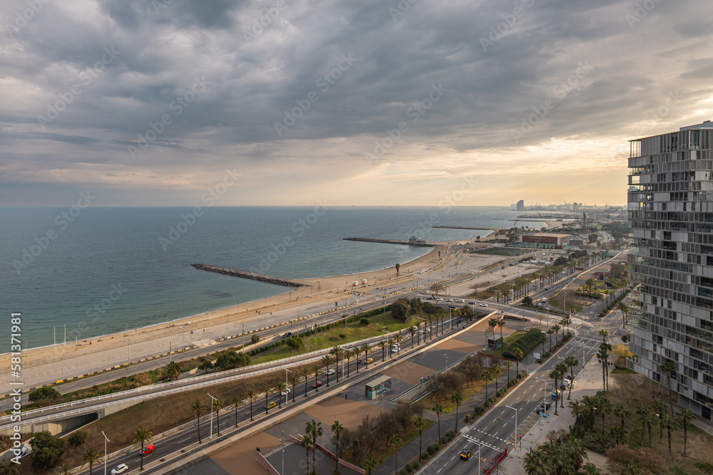 Aerial view of the beautiful landscape of Barcelona at area Diagonal Mar. Llevant and Nova Mar Bella beaches with developed infrastructure, new high-rise buildings on a warm summer evening