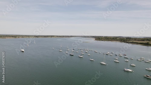 Sailboats stationed in the shallow waters of Conleau Island in Vannes Northern France, Aerial approach shot photo