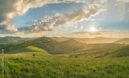 Evening rural landscape  the setting sun  sunset  spring nature  meadows and hills