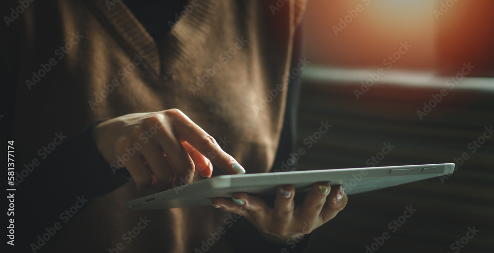 Woman's hands holding and using a digital tablet. business technology background. banner desing, IoT, internet of things. Woman's hands holding and using a digital tablet. business technology background. banner desing, IoT, internet of things.