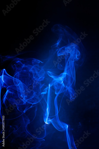 Blue smoke motion on black background. © peterkai