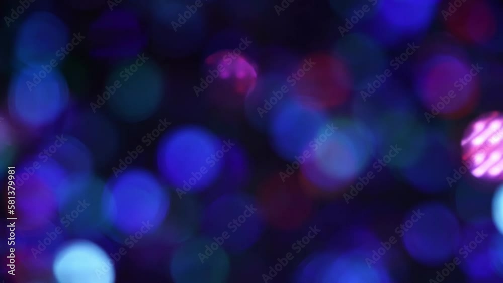 Abstract background of nice blue and purple bokeh. Defocused circles in motion. Abstract motion background of shining light leaks bokeh particles.
