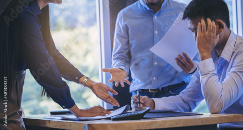 Quadro su tela Serious woman boss and colleague scolding worker employee for bad business result with thumb down in meeting