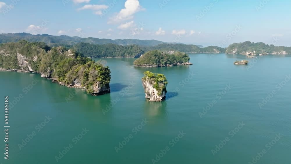 Aerial orbit shot showing beautiful Bay of Samana with tropical islands and sunlight Aerial orbit shot showing beautiful Bay of Samana with tropical islands and sunlight