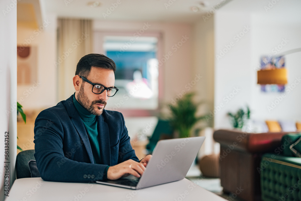 Adult businessman working over the laptop, sitting at the home office. Adult businessman working over the laptop, sitting at the home office.