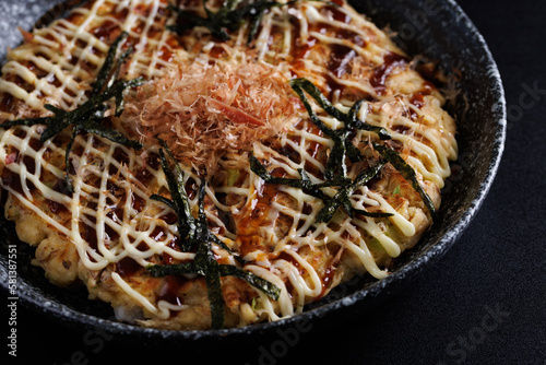 Okonomiyaki traditional japanese food isolated in black background