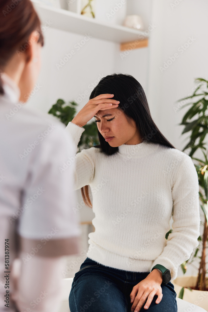 An Asian female patient had a migraine attack during the female doctor's examination. An Asian female patient had a migraine attack during the female doctor's examination.