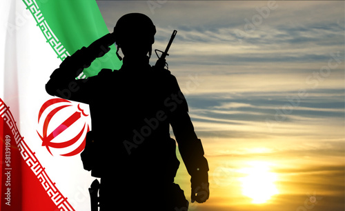 Silhouette of a saluting soldier against the sunset with Iran flag. EPS10 vector