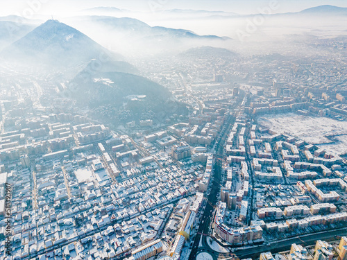 drone view of city streets covered by snow from above