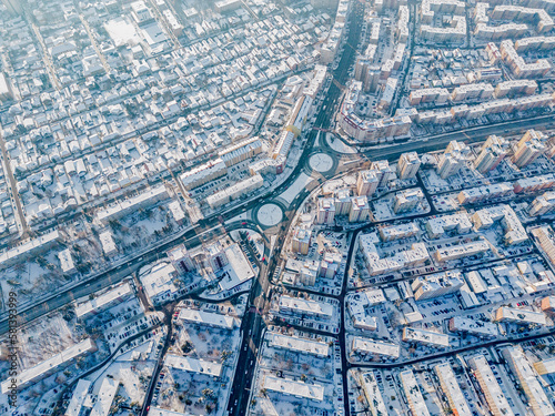 drone view of city streets covered by snow from above