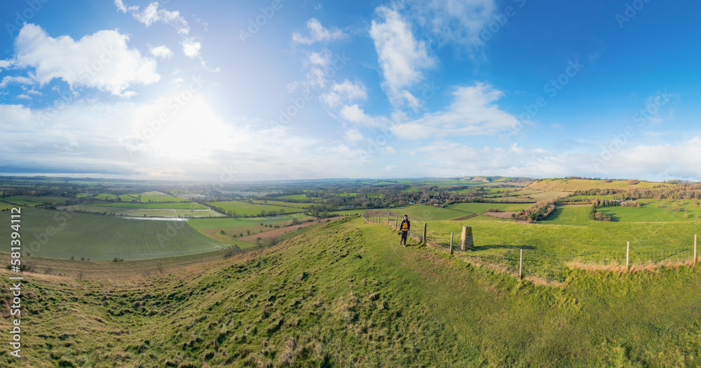 backpacker walking on footpath, beautiful hill and landscape near Pewsey, South of England, United Kingdom