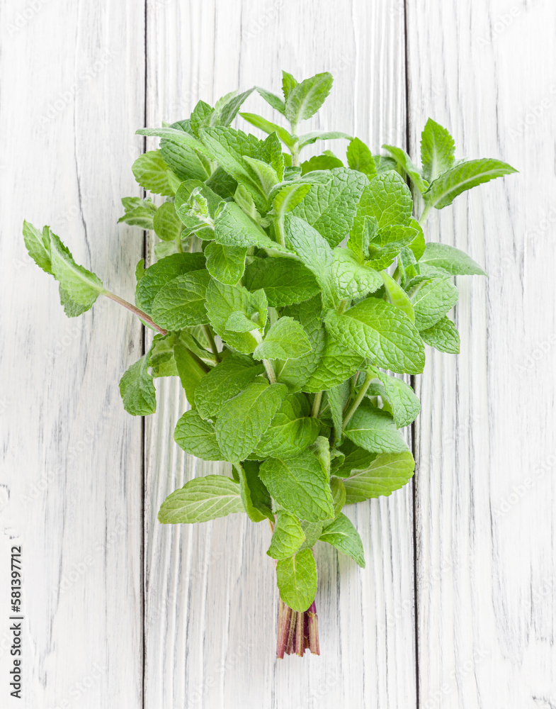Bunch of fresh melissa on white wooden background