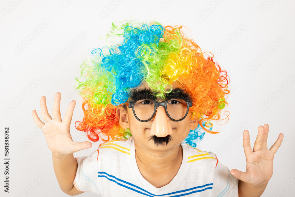 April Fool's Day. Two brothers funny kid boy clown wears curly wig colorful big nos and glasses and has mustache playing fool isolated on white background with copy space, Happy child festive decor April Fool's Day. Two brothers funny kid boy clown wears curly wig colorful big nos and glasses and has mustache playing fool isolated on white background with copy space, Happy child festive decor