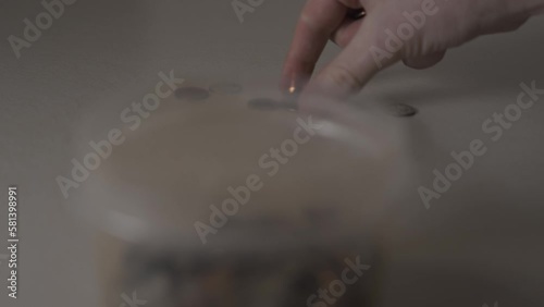 Gathering up coins from a pile. photo