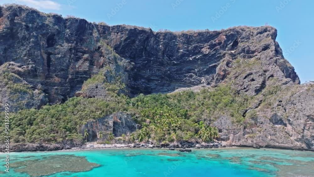 Aerial trucking shot of rocky cliffs with turquoise Caribbean sea with coral reefs in Dominican Republic Aerial trucking shot of rocky cliffs with turquoise Caribbean sea with coral reefs in Dominican Republic