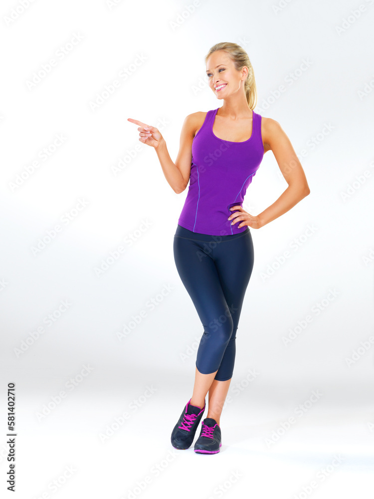 This is a workout I can get behind. Studio shot of an attractive young woman in exercise clothing against a gray background.
