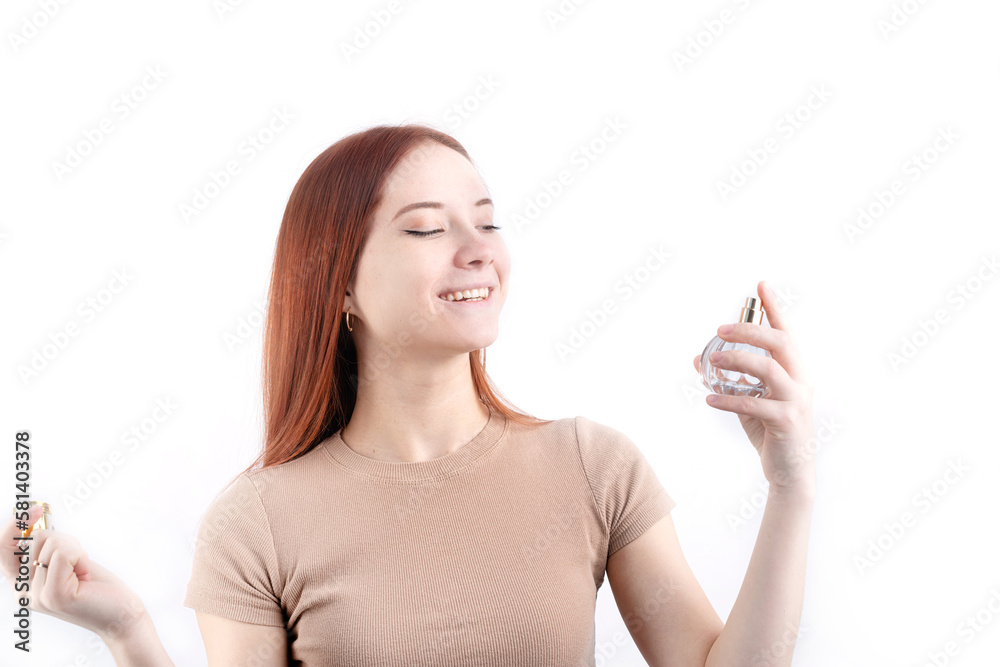 Happy young woman using perfume, holding glass bottle isolated on white background Happy young woman using perfume, holding glass bottle isolated on white background