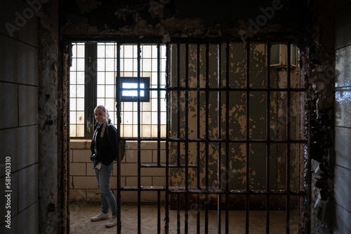Smiling young girl visiting the cell galleries of the Old Joliet Prison