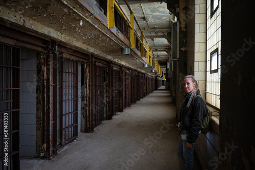 Smiling young girl visiting the cell galleries of the Old Joliet Prison